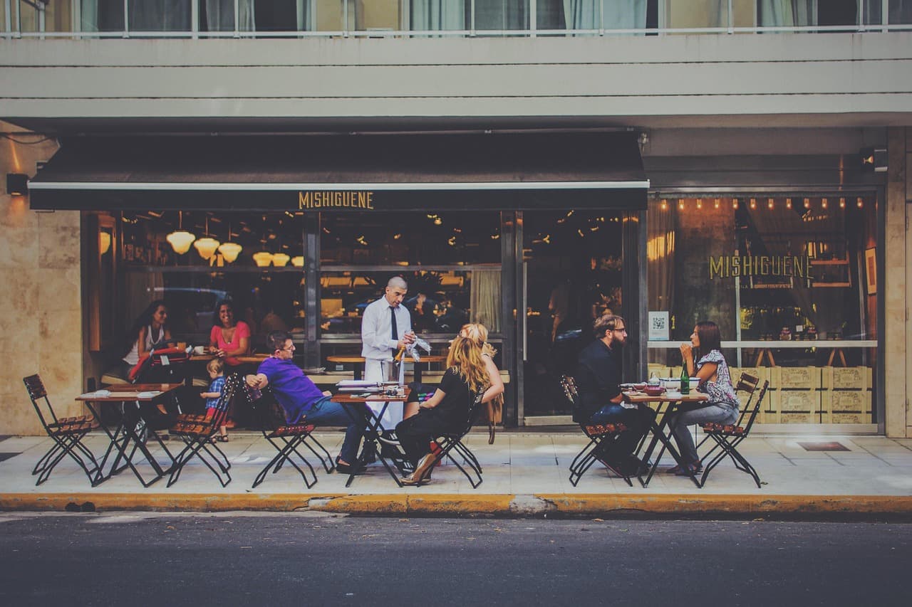 Guests enjoying drinks at an outdoor bar terrace.